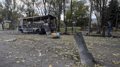 The remains of a rocket shell is seen in front of a burnt-out bus on a street in Donetsk, eastern Ukraine, October 1, 2014. (Reuters/Shamil Zhumatov)