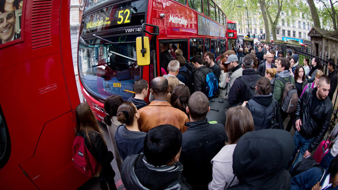 Commuters jostle for access to buses near Victoria station in London, on April 29, 2014, as a planned 48 hour underground train strike came into effect late Monday night. (AFP Photo / Leon Neal)
