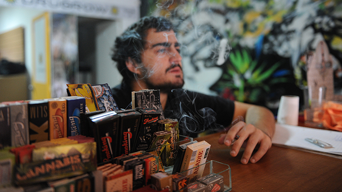 Juan Manuel, owner of the first shop dedicated to cannabis merchandising in Montevideo, smokes a joint on April 24, 2014. (AFP Photo / Miguel Rojo)