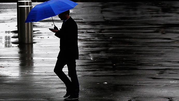A pedestrian crosses a street on a rainy day in central Sydney (Reuters / Daniel Munoz)