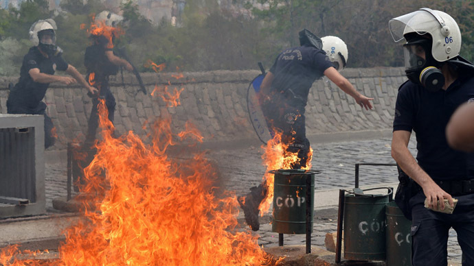 Riot police run away from the flames of a fire bomb thrown by protesters as they demonstrate to blame the ruling AK Party (AKP) government on the mining disaster in western Turkey, in Ankara May 14, 2014. (Reuters)