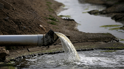 Water pours into an irrigation channel in Firebaugh, California. (AFP Photo / Getty Images / Justin Sullivan)