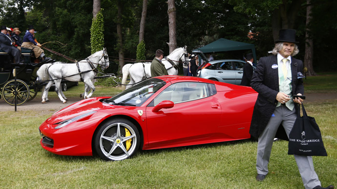 A man walks from his Ferrari as a carriage passes during the fourth day of the Royal Ascot horse racing festival at Ascot, southern England, June 21, 2013. (Reuters/Darren Staples)