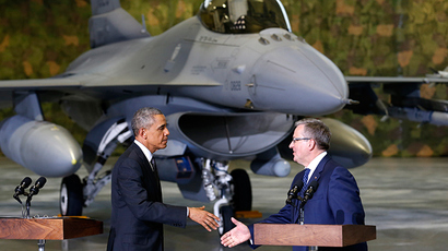 With an F-16 fighter in the background, U.S. President Barack Obama and Poland's President Bronislaw Komorowski (R) shake hands upon Obama's arrival at Chopin Airport in Warsaw June 3, 2014 (Reuters / Kevin Lamarque)