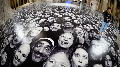 People visit the exhibition "Au Pantheon!" by French photographer JR at the Pantheon in Paris, a secular temple which contains the remains of distinguished French citizens, on June 3, 2014. (AFP Photo / Martin Bureau)