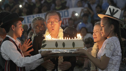 United Nations Secretary-General Ban Ki-moon blows the candles on a cake during a celebration for his 70th birthday at an event organized by Bolivia's President Evo Morales in El Torno, near Santa Cruz de la Sierra, June 13, 2014. (Reuters/David Mercado)