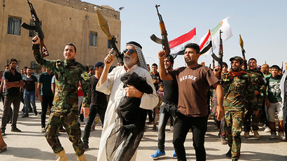 Volunteers, who have joined the Iraqi Army to fight against predominantly Sunni militants, carry weapons during a parade in the streets in Baghdad's Sadr city (Reuters / Wissm al-Okili)
