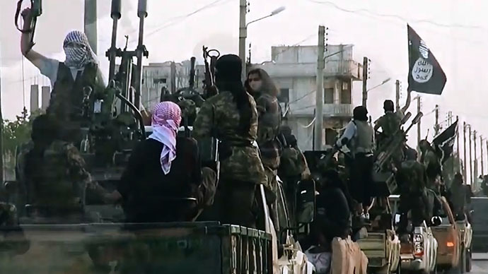 An image grab taken from a propaganda video released on March 17, 2014 by the Islamic State of Iraq and the Levant (ISIL)'s al-Furqan Media allegedly shows ISIL fighters driving on a street in the northern Syrian City of Homs. (AFP Photo)