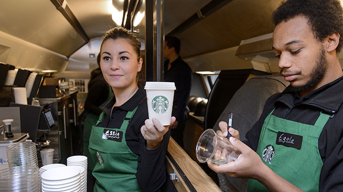 US coffee giant Starbucks employee Essia (L) and Egole prepare beverages. (AFP Photo / Fabrice Coffrini)