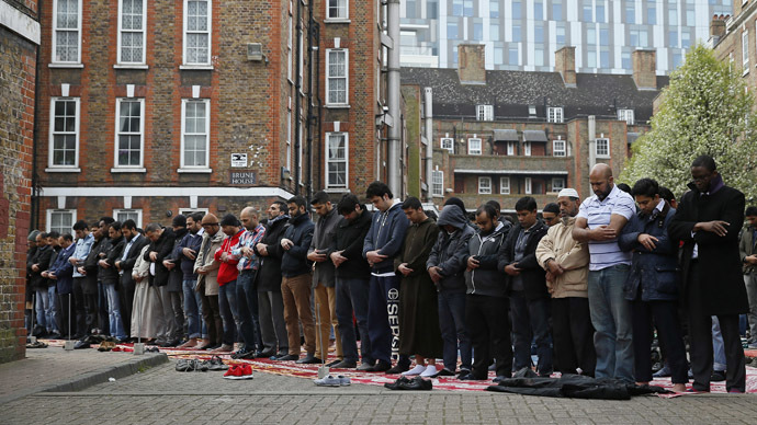 Muslims attend Friday prayers in the courtyard of a housing estate next to the small BBC community centre and mosque in east London March 28, 2014. (Reuters/Stefan Wermuth)