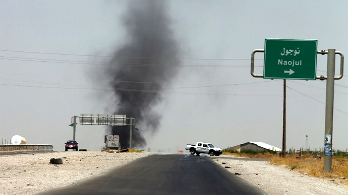 Smoke billows from an area controlled by the Islamic State of Iraq and the Levant (ISIL) between the Iraqi towns of Naojul and Tuz Khurmatu, both located north of the capital Baghdad, on June 26, 2014. (AFP Photo / Karim Sahib)