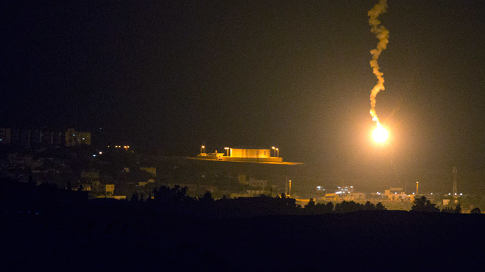 A picture taken from the southern Israeli border with the Gaza Strip shows Israeli flares illuminating the Palestinian coastal enclave, on July 7, 2014.(AFP Photo / Jack Guez)
