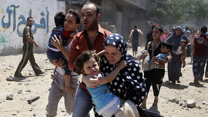 Palestinians run following what police said was an Israeli air strike on a house in Gaza city July 9, 2014. (Reuters / Majdi Fathi)