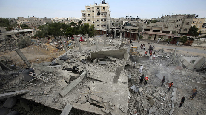 Palestinians gather as rescue workers search for victims under the rubble of a house which witnesses said was destroyed in an Israeli air strike, in Rafah in the southern Gaza Strip August 4, 2014. (Reuters/Ibraheem Abu Mustafa)