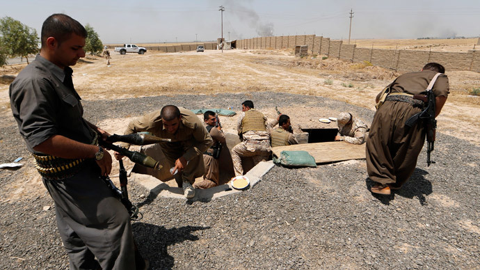 Iraqi Kurdish forces take position as they fight jihadist militants from the Islamic State of Iraq and the Levant (ISIL).(AFP Photo / Karim Sahib)