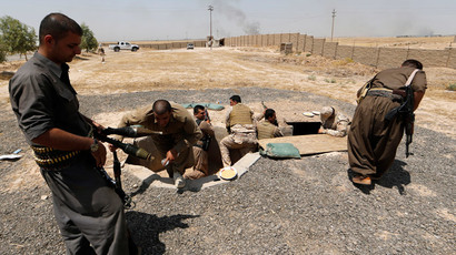 Iraqi Kurdish forces take position as they fight jihadist militants from the Islamic State of Iraq and the Levant (ISIL).(AFP Photo / Karim Sahib)