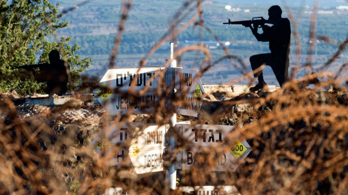 Sculptures of Israeli soldiers standing guard is seen next to a sign for tourists showing the different distances to various cities (unseen), at an army post in Mount Bental in the annexed Golan Heights, on August 28, 2014.(AFP Photo / Jack Guez)