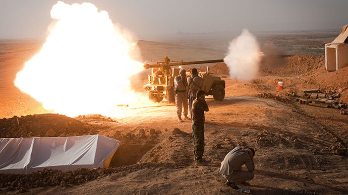 Iraqi Kurdish Peshmerga fighters fire a recoilless rifle towards Islamic State (IS) positions during heavy clashes in Tuz Khurmatu in Salaheddin province about 88 kilometres (55 miles) south of Kirkuk on August 31, 2014. (AFP Photo / Jm Lopez)