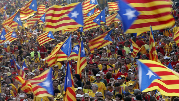 People hold "estelada" flags, Catalan separatist flags, as they form a "V" for "vote" during a gathering to mark the Calatalonia day "Diada" in central Barcelona September 11, 2014. (Reuters/Albert Gea)