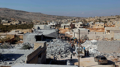 Residents inspect damaged buildings in what activists say was a U.S. strike, in Kfredrian, Idlib province September 23, 2014 (Reuters / Abdalghne Karoof)