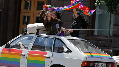 Gay rights activists wave flags from a car during a protest outside the Mayor's office in Moscow (Reuters / Maxim Shemetov)