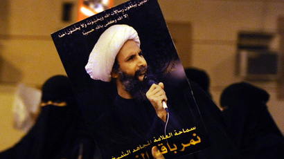 A protester holds up a picture of Sheikh Nimr al-Nimr (Reuters / Stringer)