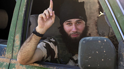 An Islamic State fighter gestures from a vehicle in the countryside of the Syrian Kurdish town of Kobani, after the Islamic State fighters took control of the area October 7, 2014. (Reuters/Stringer)