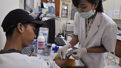 A medical technician takes a blood sample from a patient to check for dengue and typhoid at a government health center in Jakarta (AFP Photo)