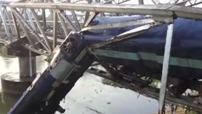Train derails while navigating bridge in India, multiple injuries (VIDEO)
