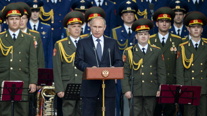 Russian President Vladimir Putin, center, speaks at the opening of the International Military-Technical Forum ARMY-2015 in the military-patriotic recreation park Patriot in Kubinka, Moscow Region. (RIA Novosti/Alexander Vilf)