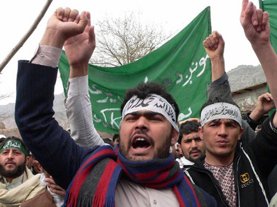 Afghan soldier killed at massacre scene as Afghans rage on streets