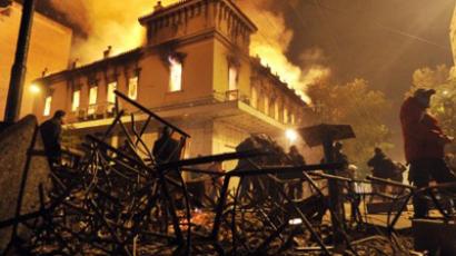 A fire engulfs a store during clashes between protesters and riot police near the Greek parliament in Athens on February 12, 2012 (AFP Photo / Louisa Gouliamaki)