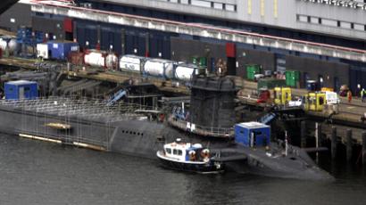 A trident submarine is pictured with a long lens at the Faslane naval base, Scotland. (AFP Photo / Maurice McDonald)