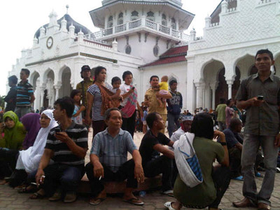People gather outside the Baiturrahman mosque after an earthquake hit Banda Aceh (REUTERS/Stringer)