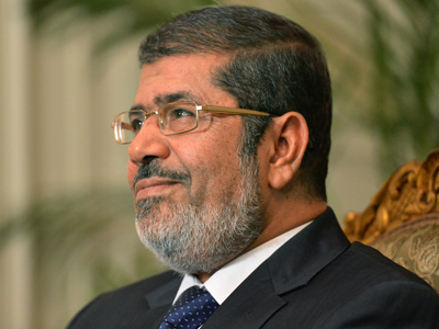 Morsi calls power extension 'temporary' as Egyptians swarm streets in protest