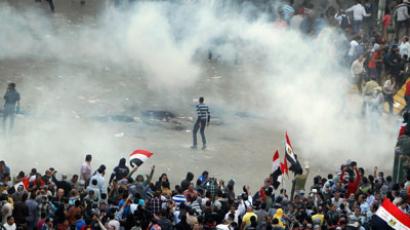 Protesters run from tear gas released by riot police during clashes at Tahrir square in Cairo November 23, 2012.(Reuters / Mohamed Abd El Ghany)