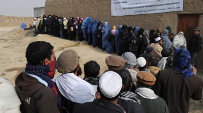 Afghans line up to receive winter supplies at a UNHCR distribution centre for needy refugees on the outskirts of Kabul (AFP Photo / Shah Marai)