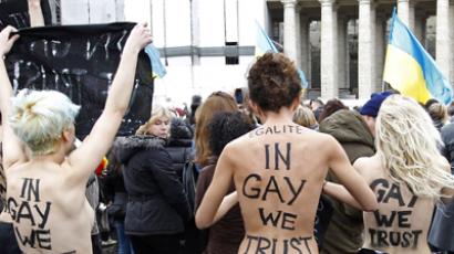 An activist from women's rights protest group Femen is restrained as Pope Benedict XVI leads his Angelus prayer from the window of his private apartment in Saint Peter's Square at the Vatican January 13, 2013. (Reuters / Giampiero Sposito)