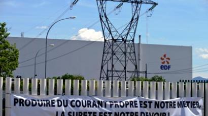 A banner reading "Generating clean power is our business, safety is our duty!" hung on a gate in front of the nuclear powerplant in Fessenheim, eastern France. (AFP Photo/Sebastien Bozon)
