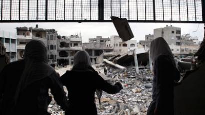 Palestinian school girls look at destroyed buildings from their school, which witnesses said was damaged in an Israeli air strike, in Gaza City November 24, 2012.(Reuters / Ahmed Zakot)