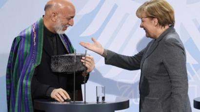 German Chancellor Angela Merkel (R) chats with Afghanistan's President Hamid Karzai (Reuters / Tobias Schwarz)