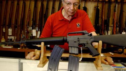 Gun shop manager Stephan Romanoff displays an AR-15 rifle and two magazines (Jeff Swensen/Getty Images/AFP)