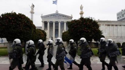 Anti-riot policemen walk in front of the Athens' University during a 48-hour general strike on February 10, 2012. (AFP Photo / Louisa Gouliamaki)