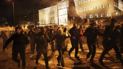 Protesters run away from tear gas during clashes between protesters and riot police near the Greek parliament in Athens on February 12, 2012. (AFP Photo / Angelos Tzortzinis) 
