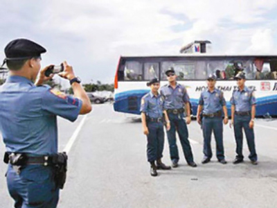 Filipino cops face demotion over posing in front of hijacked bus