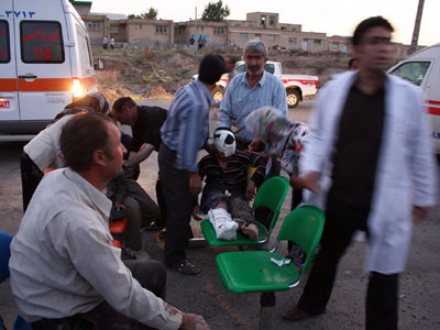 Iranians who were Injured in an earthquake receive medical treatments in the town of Varzaqan some 60 kms northeast of Tabriz.(AFP Photo / Hamed Nazari)