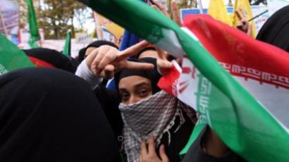 Iranian students flash the victory sign and wave their national flag during a rally outside the former US embassy in Tehran  (AFP Photo / BEHROUZ MEHRI)