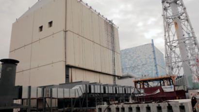 The unit No.1 (L) and No. 2 reactor building of the tsunami-crippled Fukushima Daiichi nuclear power plant are seen through a window in a bus while Japan's new Prime Minister Shinzo Abe inspects the nuclear power plant power plant in Fukushima Prefecture December 29, 2012.(Reuters / Pool New)
