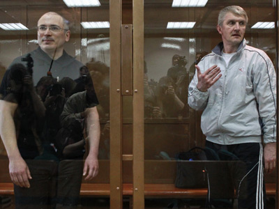 Moscow court reduces jail term for Khodorkovsky, partner