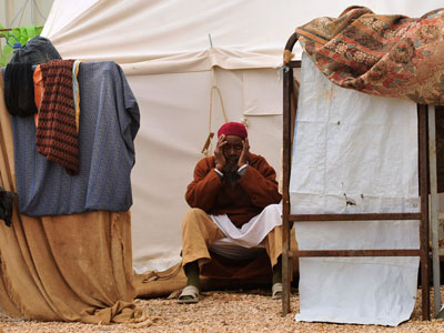 A man sits at at a camp for refugees from Tawargha in Benghazi January 31, 2012.(Reuters / Esam Al-Fetori)